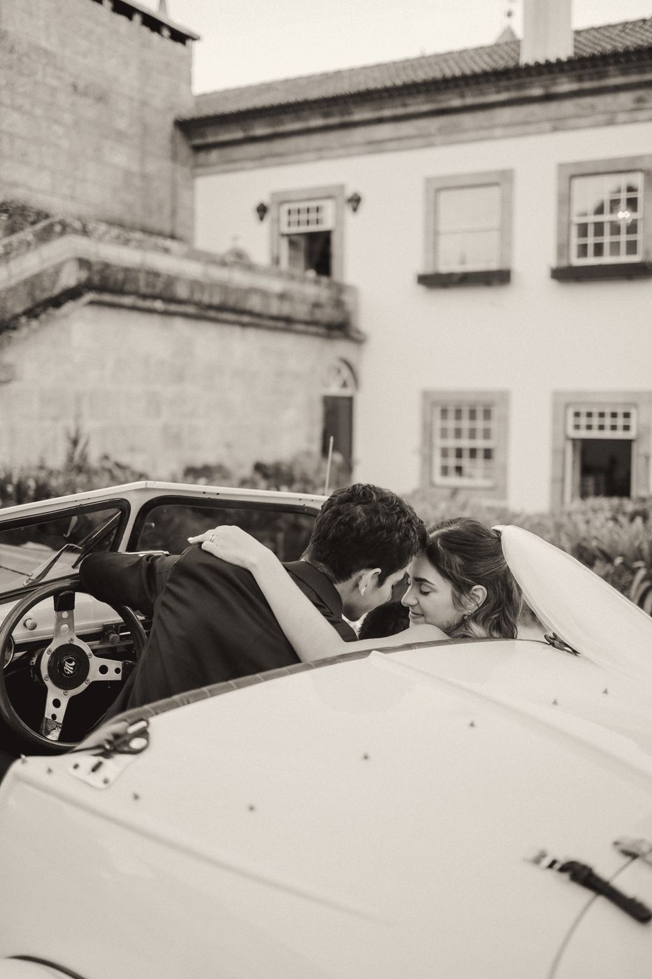 Couple kissing in a vintage convertible